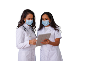 Female medical professionals wearing face masks discussing patient data on digital tablet, collaborating on healthcare technology with a transparent background