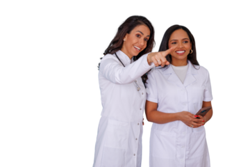 Female medical professionals in lab coats pointing, smiling, cooperating, and discussing healthcare information