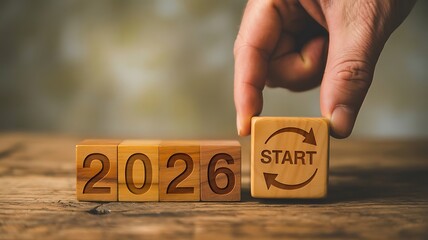 2026 New Beginnings Concept &ndash; Wooden Blocks with Start Symbol and Year Transition