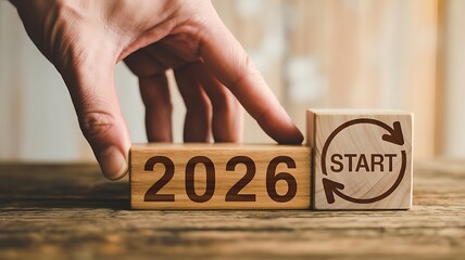 2026 New Beginnings Concept &ndash; Wooden Blocks with Start Symbol and Year Transition
