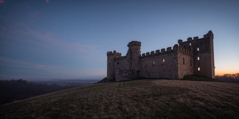 Medieval castle ruins in Rudno at dusk, historical preservation efforts