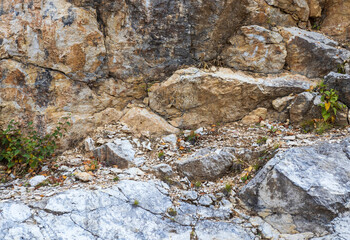 A fragment of limestone rock on a section of a stone canyon on an autumn day