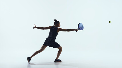 Woman extending arm to hit ball with paddle isolated on white. Concept of leadership under pressure, decision making, and confidence in competitive business environments.