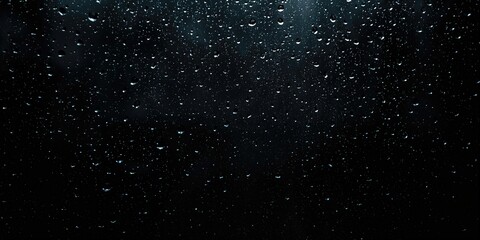 Obraz premium Raindrops sliding across a glass pane against a dark backdrop, illustrating condensation and cleaning challenges