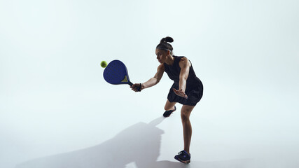 Woman jumps and hits ball with padel racket on white background. Concept of UI motion design, web animations, interface dynamics, and professional sports training visuals.