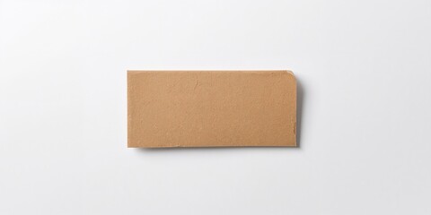 White paper background with a cardboard sheet featuring an empty space, suitable for layout and text placement