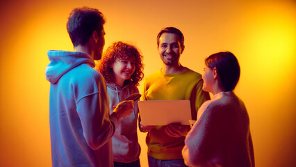 Business team interacting around laptop during digital discussion. Concept of technology adoption,...