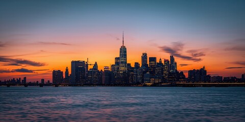 Fototapeta premium City skyline at sunset viewed from a high vantage point, urban landscape highlighting building silhouettes at dusk