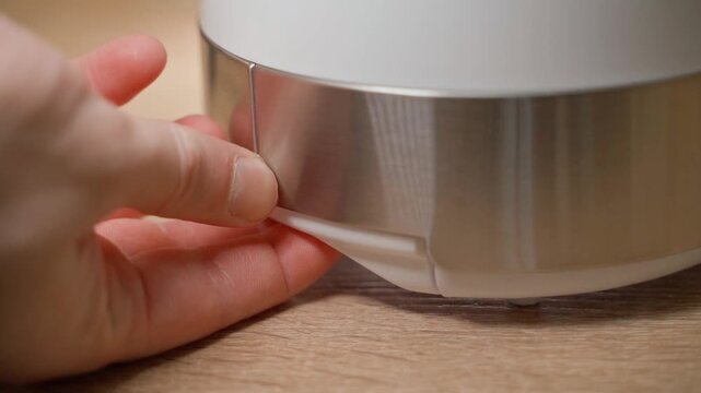 Removing the crumb tray to clean the toaster, close-up