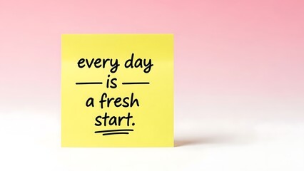 Yellow sticky note with handwritten motivational quote about fresh starts against a soft pink background