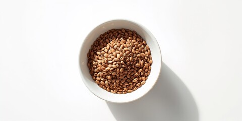 White ceramic bowl holding flax seeds for dietary benefits and oil production, health-conscious use