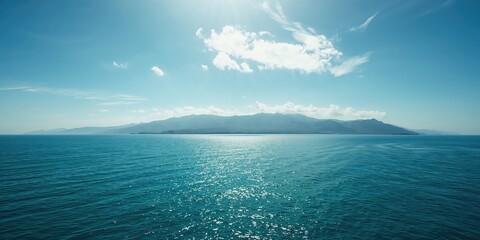 Expansive ocean scene with multiple mountain tiers under a soft cloudy canopy, ideal for scenic background uses