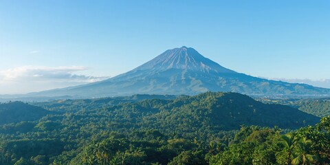 Fototapeta premium View of a mountain surrounded by tropical forest under a morning sky, suitable for nature-themed backgrounds, Earth Day