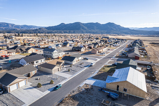 Aerial view of homes nestled in a valley, with the mountains rising in the distance, Buena Vista, Colorado, United States.