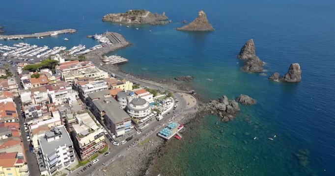 Aerial view of the waterfront of Aci Trezza, Sicily, Italy. Opposite the town are the Cyclopean Isles, a small archipelago formed as a result of intense volcanic activity.