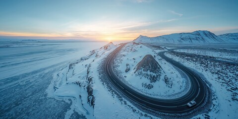 Drone shot of a highway crossing Iceland's snowy terrain, highlighting winter travel safety
