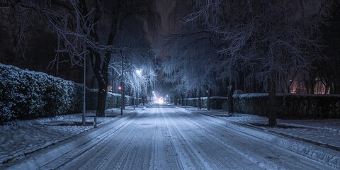 Fototapeta premium Snow-covered empty street with winter atmosphere, seasonal change and urban preservation
