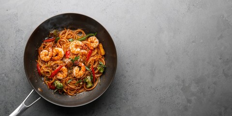 Shrimp stir-fried with noodles and vegetables in a wok, quick cooking for healthy meals