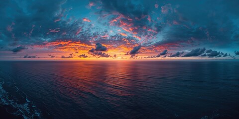 Aerial view of a dusk landscape with sunset rays over the Pacific Ocean and dramatic cloudscape, Earth Day