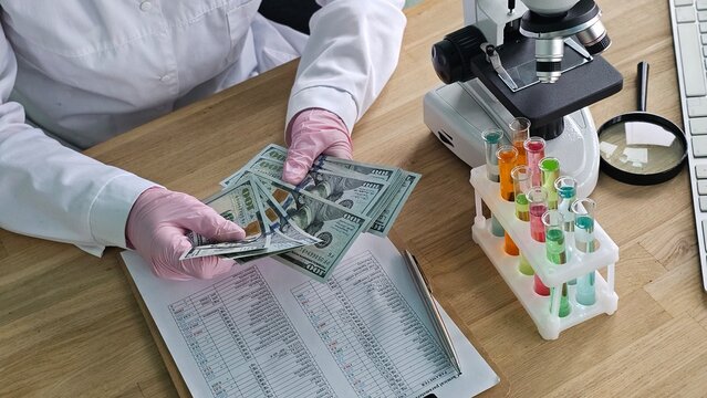 Scientist examines cash next to laboratory equipment in a research - Powered by Adobe