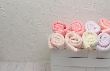 A top view of fresh pink folded towels on a light background, offering a clean mockup with ample space for design additions.