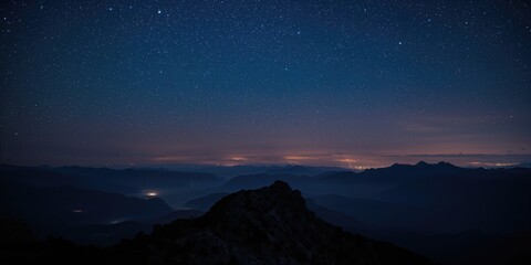 Fototapeta premium Mountain landscape at night highlighting rugged terrain and starry sky, ideal for scenic backdrop use