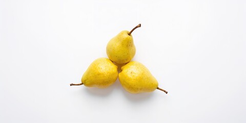 Three ripe golden pears arranged on a white background, fresh fruit for healthy eating
