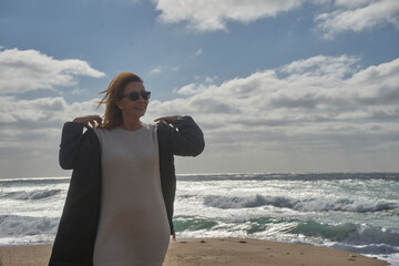 Woman enjoying windy day at a sunny beach