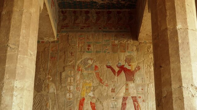 Colored hieroglyphs on the walls of the sacrificial room of the Hatshepsut funeral temple in Luxor. The temple of Ancient Egypt.