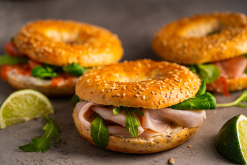 Variety of Bagel sandwiches with ricotta, prosciutto or chicken ham or salmon and microgreens,...