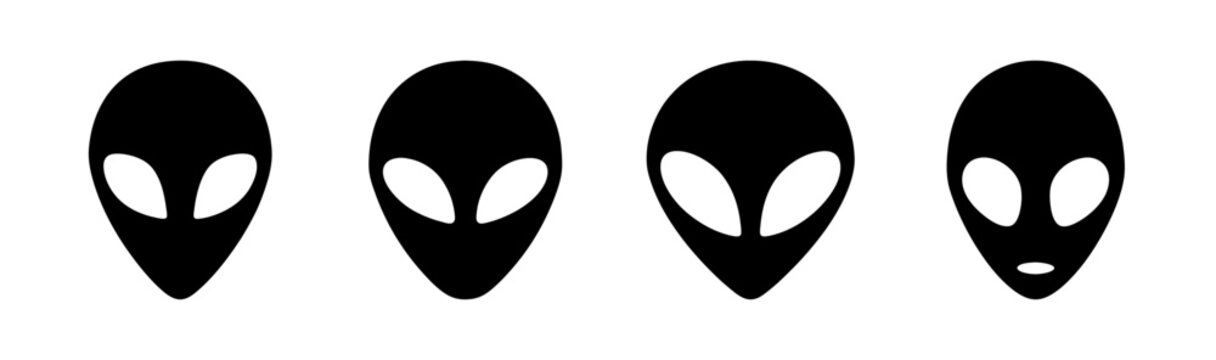 Four stylized alien heads with elongated shapes and distinctive eye placements in black and white
