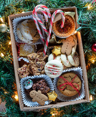 A close up look into a DIY holiday cookie box with homemade baked goods.