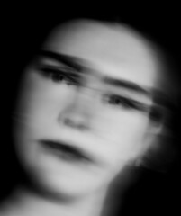 Blur effect face of a beautiful woman closeup abstract art in black and white monochrome
