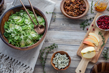 Raw shredded Brussels Sprouts with other fresh ingredients to make a salad.