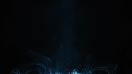 Cascading blue particles transforming into mysterious vapor on dark background