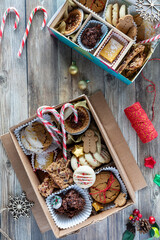 Top down view of DIY festive cookie boxes on a rustic wooden table.