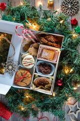 Top down view of a homemade cookie box surrounded by Christmas decorations.