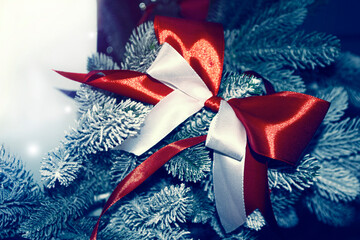 New Year's greeting card. A Christmas bow and ribbon decorate the tree.