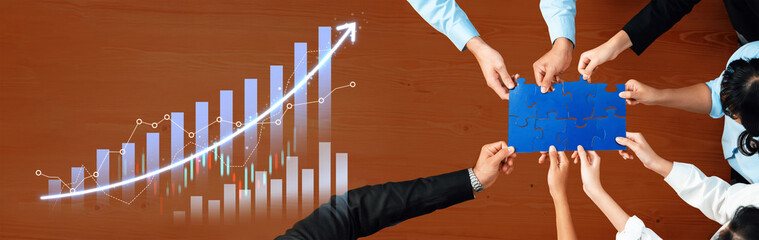 A diverse business team actively collaborates on a growth strategy. The image showcases hands joining over a blue paper, emphasizing teamwork toward common goals. Scalp