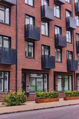 Fototapeta premium Modern Brick Apartment Building With Black Balconies In Hyllie Malmo Sweden Sustainable Urban Living And Contemporary Architecture Design
