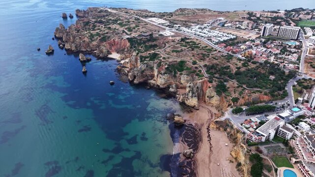 Aerial view of beautiful praia do camilo beach and coastline in lagos portugal algarve on a sunny day
