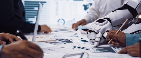 A dynamic workspace showcasing collaboration between humans and robots, focusing on data analysis. Charts and technology tools create an innovative atmosphere for teamwork.Noogenesis