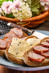 Sandwich with ham, eggs and tomato.