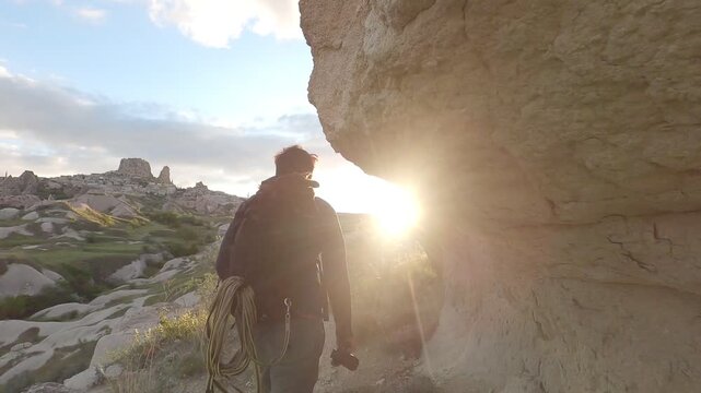 Man carrying dog in backpack exploring Uchisar town in Cappadocia, Turkey