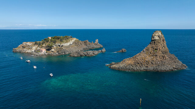 Aerial view of the Cyclopean Isles, noted for their rows of basaltic columns piled one above another, lie not far from Aci Trezza off the eastern coast of Sicily in the Mediterranean Sea, Italy. 