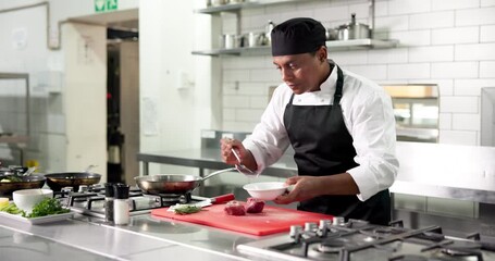 Chef, man and cooking meat with oil, pepper and catering process in restaurant kitchen. Beef, lunch and meal prep with mature culinary artist for cuisine, seasoning and protein with salt on food