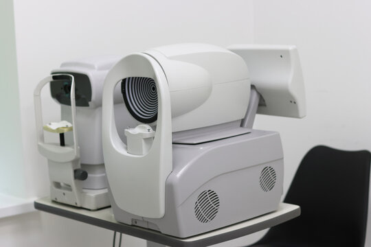 Ophthalmic diagnostic devices: non-contact tonometer and corneal topographer side by side. Used for measuring eye pressure and mapping corneal shape in eye care clinics.