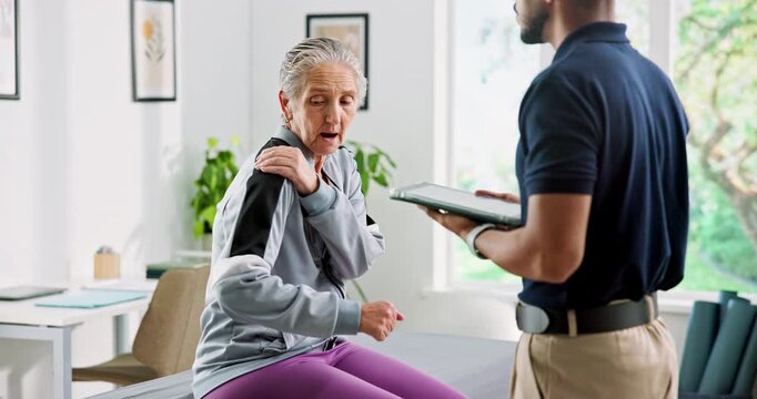 Physiotherapy, tablet and old woman with shoulder pain for medical service, wellness and consulting. Healthcare, tech and physical therapist with mature patient for diagnosis, arthritis or tendinitis