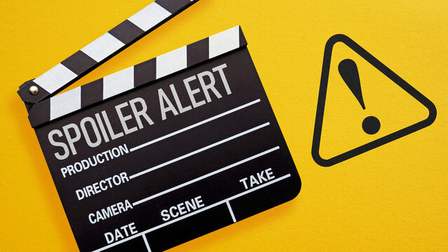 Spoiler Alert Concept with Film Clapperboard and Warning Sign on Yellow Background