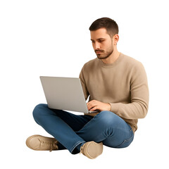 Young man sitting cross legged on the floor typing on a laptop computer with focused expression